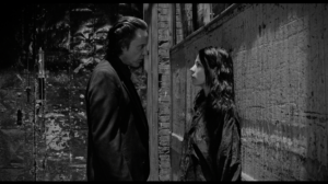 Black and White Photo of Taller Man looking at a shorter younger woman