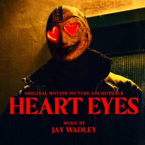 A person wearing a mask with red heart-shaped eyes