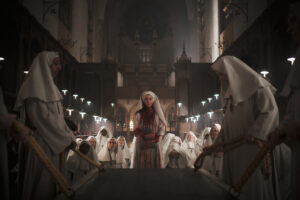 A bunch of nuns surrounding one who is bloodied