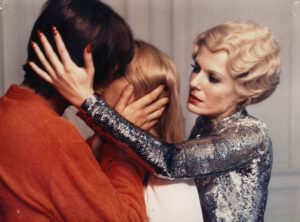 Man and woman being held together to kiss