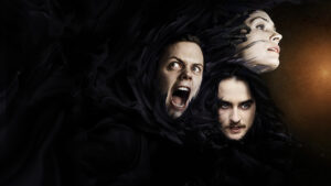 Three young faces showing against a pitch black background