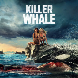 Two women sitting upon a rock as a bloodied Killer Whale passes by them