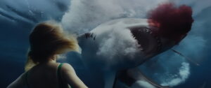 Woman underwater with a great white shark